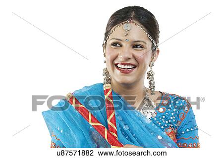 Stock Image - Gujarati woman with dandiya sticks . Fotosearch