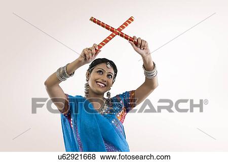 Stock Photo - Gujarati woman with dandiya sticks . Fotosearch