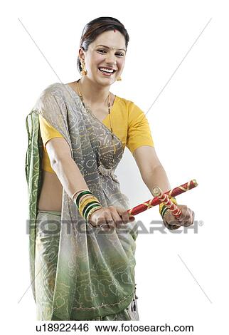Gujarati woman with dandiya sticks View Large Photo Image Stock Photograph - Gujarati woman with dandiya sticks . Fotosearch