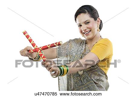 Stock Photography - Gujarati woman with dandiya sticks . Fotosearch