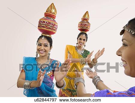 Stock Photo - Gujarati women dancing with a kalash on their head . Fotosearch