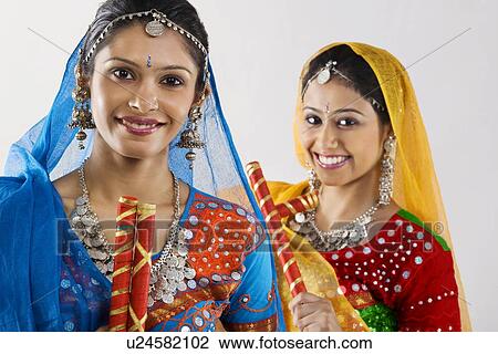 Stock Image - Gujarati women with dandiya sticks . Fotosearch