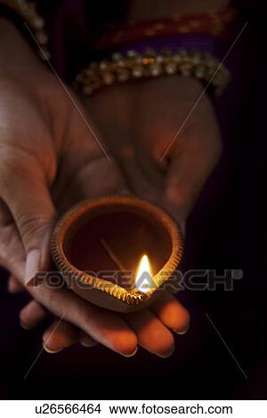 Hands holding a diya View Large Photo Image Picture - Hands holding a diya . Fotosearch