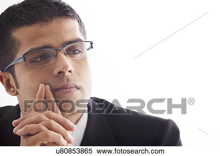 Handsome business man lost in thought View Large Photo Image Stock Photography - Handsome business man lost in thought . Fotosearch
