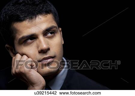 Handsome male executive looking away View Large Photo Image Stock Image - Handsome male executive looking away . Fotosearch