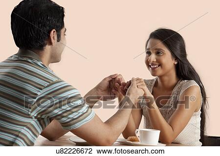 Handsome young couple on date together View Large Photo Image Stock Image - Handsome young couple on date together . Fotosearch