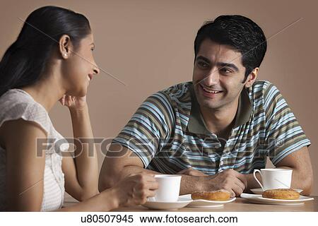 Stock Photography - Handsome young pair having refreshment drink together . Fotosearch
