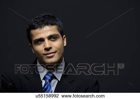 Happy businessman contemplating over black background View Large Photo Image Stock Image - Happy businessman contemplating over black background . Fotosearch