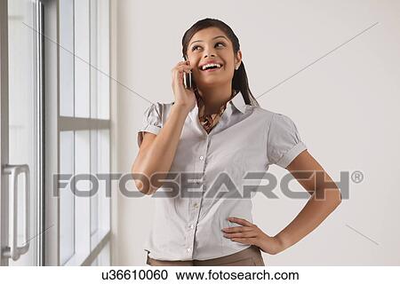 Happy businesswoman speaking on mobile phone View Large Photo Image Stock Image - Happy businesswoman speaking on mobile phone . Fotosearch
