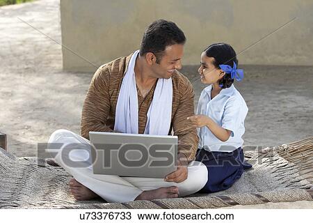 Happy father with his little daughter using laptop View Large Photo Image Stock Image - Happy father with his little daughter using laptop . Fotosearch