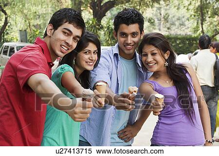 Happy friends holding ice cream View Large Photo Image Stock Photography - Happy friends holding ice cream . Fotosearch