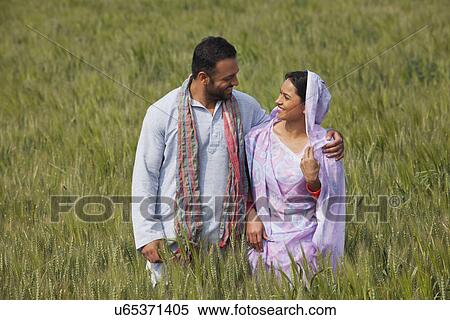 Happy Indian couple standing in wheat field View Large Photo Image Stock Photography - Happy Indian couple standing in wheat field . Fotosearch