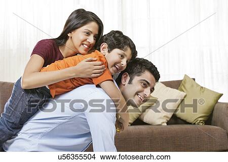 Picture - Happy Indian family of three at home . Fotosearch
