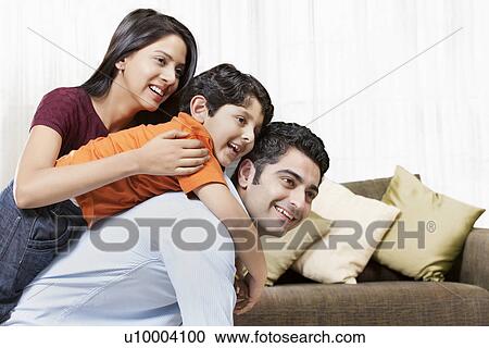 Happy Indian family of three playing at home View Large Photo Image Stock Image - Happy Indian family of three playing at home . Fotosearch