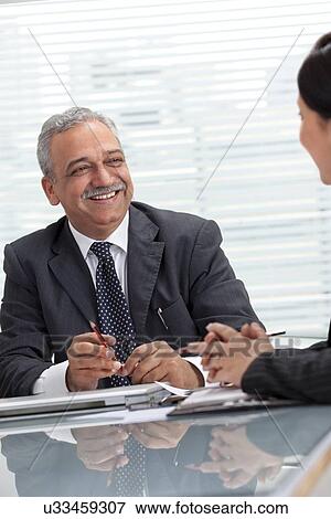 Happy mature executives having discussion together View Large Photo Image Stock Photo - Happy mature executives having discussion together . Fotosearch