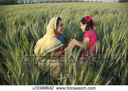 Happy mother and daughter playing in the field View Large Photo Image Stock Image - Happy mother and daughter playing in the field . Fotosearch