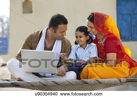 Happy rural family using laptop View Large Photo Image Stock Image - Happy rural family using laptop . Fotosearch