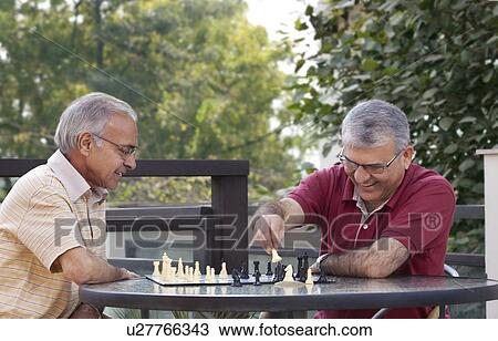 Happy senior men playing chess together View Large Photo Image Stock Image - Happy senior men playing chess together . Fotosearch