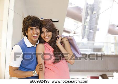 Happy young couple on shopping together View Large Photo Image Stock Photo - Happy young couple on shopping together . Fotosearch