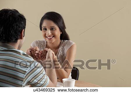 Happy young woman spending lovely time with her date View Large Photo Image Stock Photography - Happy young woman spending lovely time with her date . Fotosearch