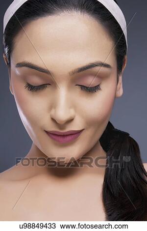 Head shot of beautiful calm female with eyes closed over colored background View Large Photo Image Stock Image - Head shot of beautiful calm female with eyes closed over colored background . Fotosearch