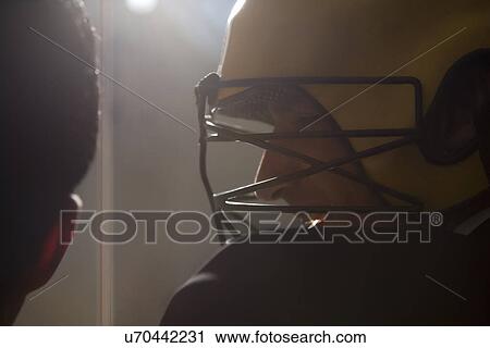 Stock Image - Hockey player with helmet . Fotosearch