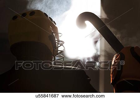 Stock Photo - Hockey player with hockey stick . Fotosearch