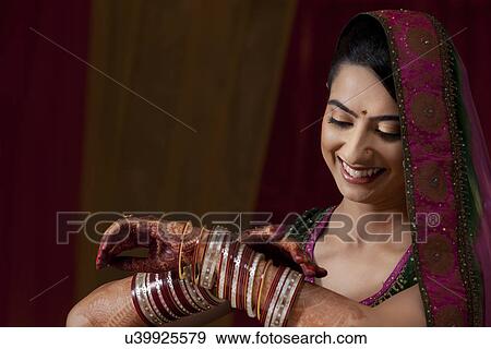 Indian bride admiring her bangles View Large Photo Image Stock Photo - Indian bride admiring her bangles . Fotosearch