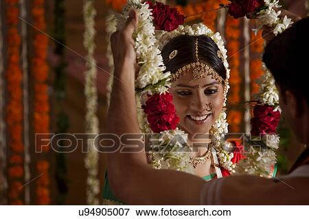 Indian bride and groom during wedding ceremony View Large Photo Image Stock Photo - Indian bride and groom during wedding ceremony . Fotosearch
