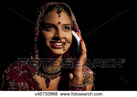 Stock Photo - Indian bride talking on a mobile phone . Fotosearch