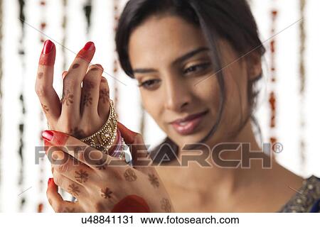 Indian bride wearing bangles View Large Photo Image Stock Image - Indian bride wearing bangles . Fotosearch