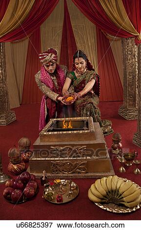 Indian couple during their wedding ceremony View Large Photo Image Stock Photo - Indian couple during their wedding ceremony . Fotosearch