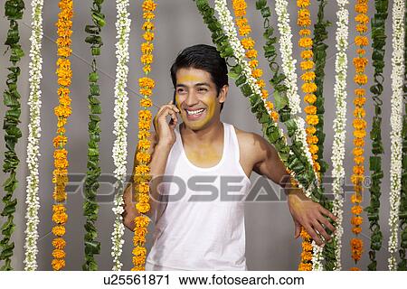 Indian groom talking on a mobile phone View Large Photo Image Stock Image - Indian groom talking on a mobile phone . Fotosearch