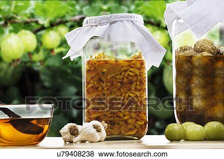 Stock Photo - Jars filled with garlic and amla pickle . Fotosearch