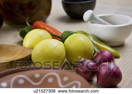 Stock Photo - Lemons, onions and ghost chillies . Fotosearch