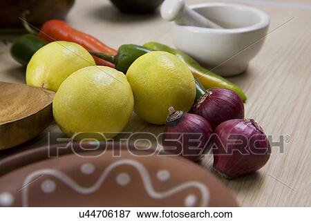 Stock Photo - Lemons, onions and ghost chillies . Fotosearch