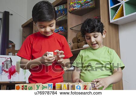 Little boys playing with wooden toy blocks View Large Photo Image Picture - Little boys playing with wooden toy blocks . Fotosearch