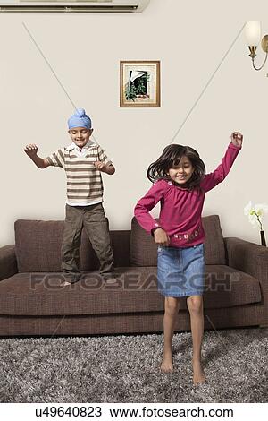 Little brother and sister playing at home View Large Photo Image Stock Image - Little brother and sister playing at home . Fotosearch