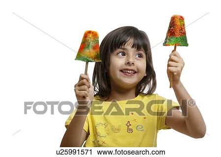 Little girl holding two ice lollies View Large Photo Image Stock Image - Little girl holding two ice lollies . Fotosearch