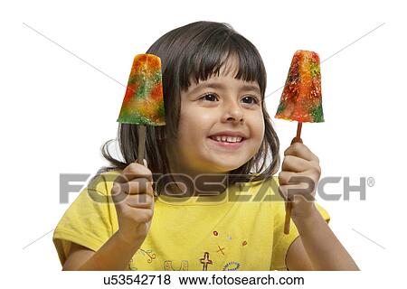 Little girl holding two ice lollies View Large Photo Image Stock Photo - Little girl holding two ice lollies . Fotosearch