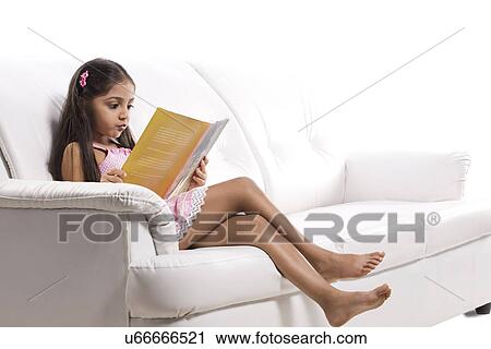 Little girl reading a story book View Large Photo Image Stock Image - Little girl reading a story book . Fotosearch