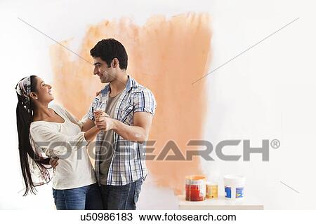 Loving young couple enjoying while dancing at home View Large Photo Image Stock Image - Loving young couple enjoying while dancing at home . Fotosearch