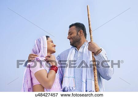 Low angle view of an Indian couple smiling View Large Photo Image Stock Photo - Low angle view of an Indian couple smiling . Fotosearch