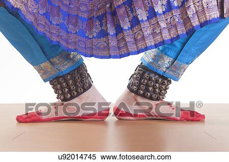 Low section of dancer's feet performing Bharatanatyam over white background View Large Photo Image Stock Photography - Low section of dancer's feet performing Bharatanatyam over white background. Fotosearch