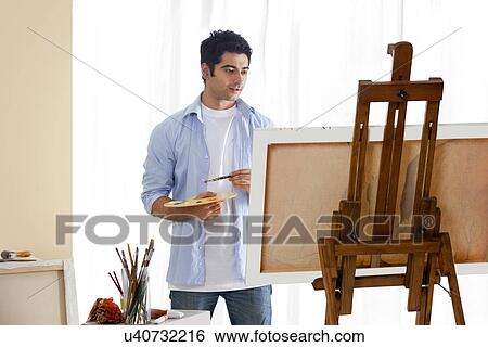 Male artist at work in studio View Large Photo Image Stock Photograph - Male artist at work in studio . Fotosearch