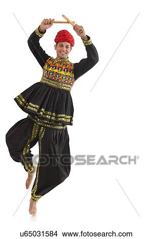 Male dandiya dancer dancing with sticks View Large Photo Image Picture - Male dandiya dancer dancing with sticks . Fotosearch