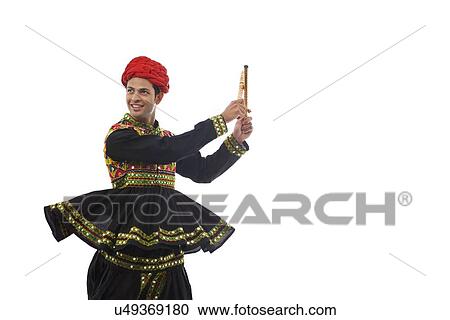 Male dandiya dancer dancing with sticks View Large Photo Image Stock Image - Male dandiya dancer dancing with sticks . Fotosearch