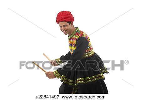 Male dandiya dancer dancing with sticks View Large Photo Image Stock Photo - Male dandiya dancer dancing with sticks . Fotosearch