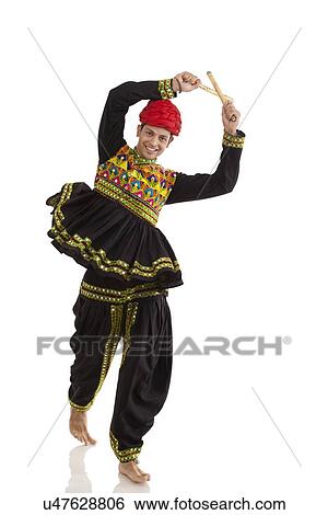 Male dandiya dancer dancing with sticks View Large Photo Image Stock Photograph - Male dandiya dancer dancing with sticks . Fotosearch