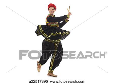 Male dandiya dancer dancing with sticks View Large Photo Image Stock Photography - Male dandiya dancer dancing with sticks . Fotosearch